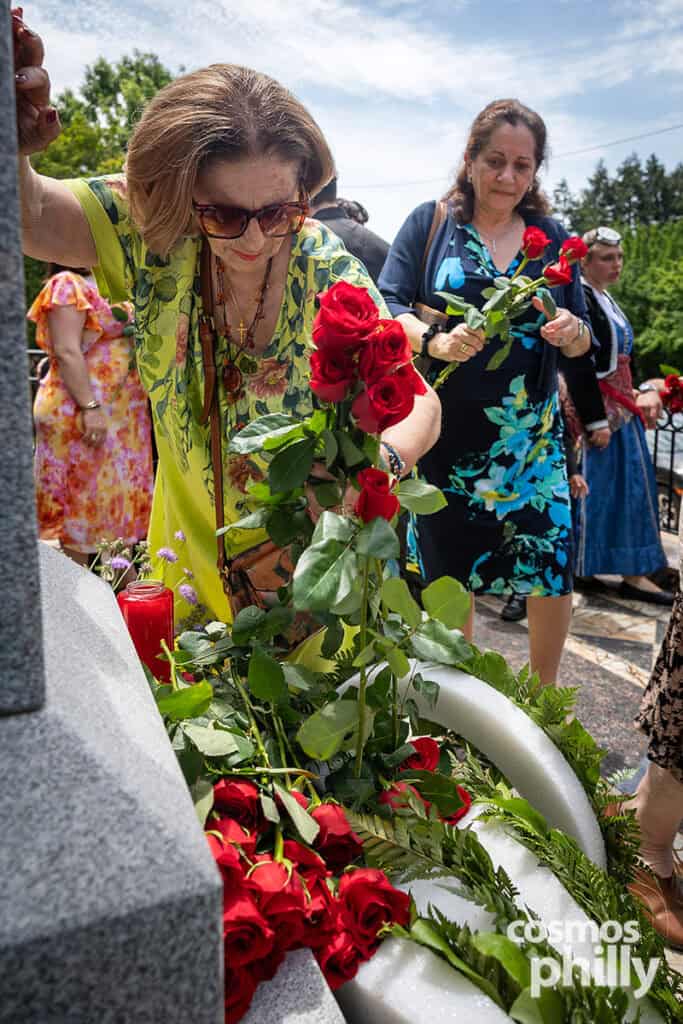 Parishioners lay red roses at the Pontian Genocide monument during the commemoration in Upper Darby.