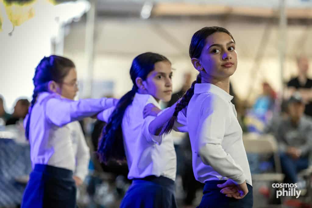 Scenes from the St. Demetrios Greek Wine and Food Festival in Upper Darby, with guests, food, dancing, volunteers, and activity under the festival tent.