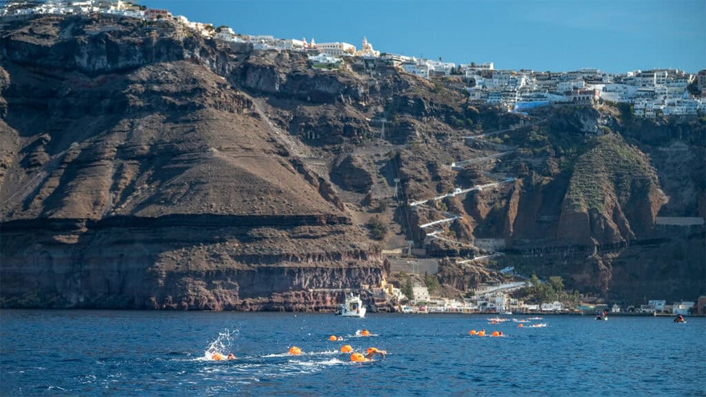 Swimmers cross the Santorini Caldera during the Santorini Experience open-water race.