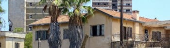 Abandoned buildings behind a fence in Varosha, Famagusta, a district tied to unresolved Cyprus property-rights claims.