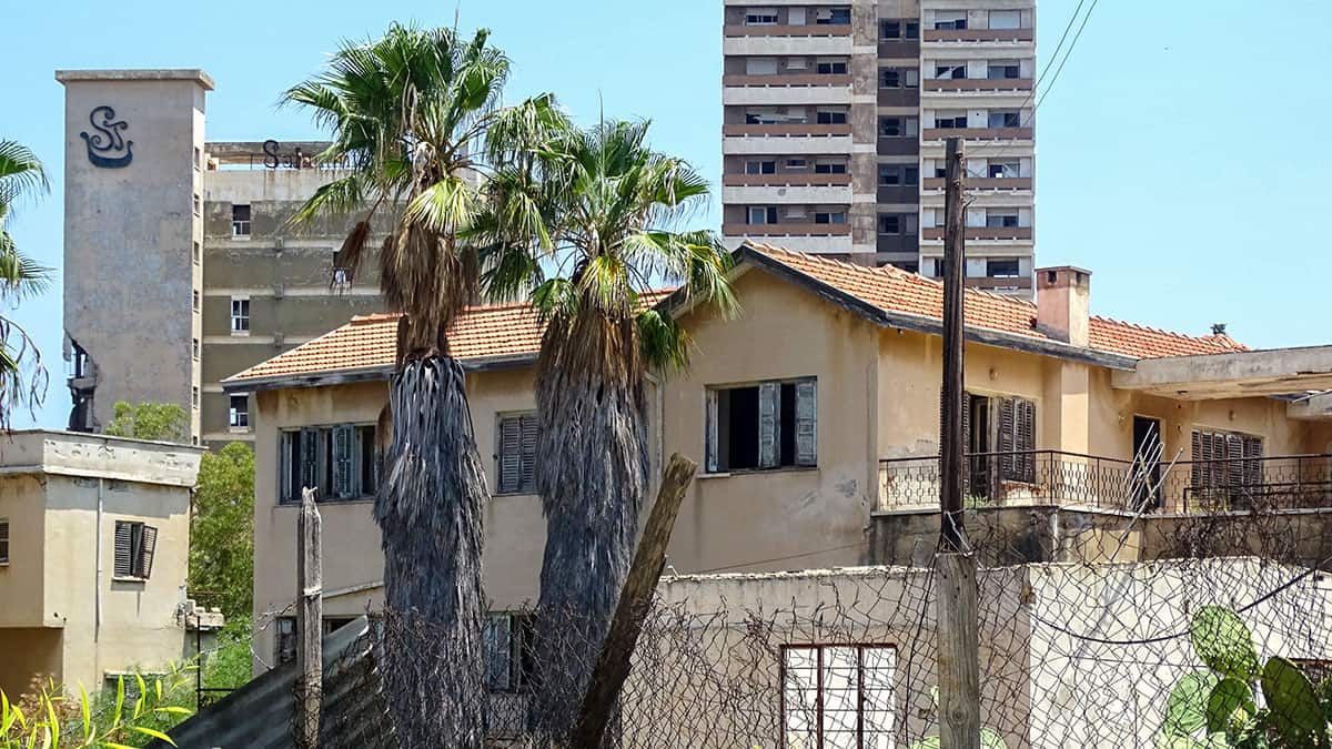 Abandoned buildings behind a fence in Varosha, Famagusta, a district tied to unresolved Cyprus property-rights claims.