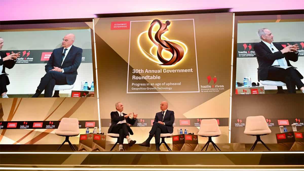 Nikos Dendias seated onstage during the 30th Economist Government Roundtable in Lagonisi