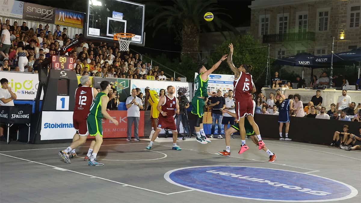 Players compete during a night game at the Stoiximan AegeanBall Festival in Miaouli Square, Syros.