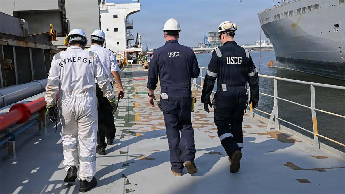 U.S. Coast Guard inspectors walk across a commercial vessel during a Port State Control examination in Baltimore.