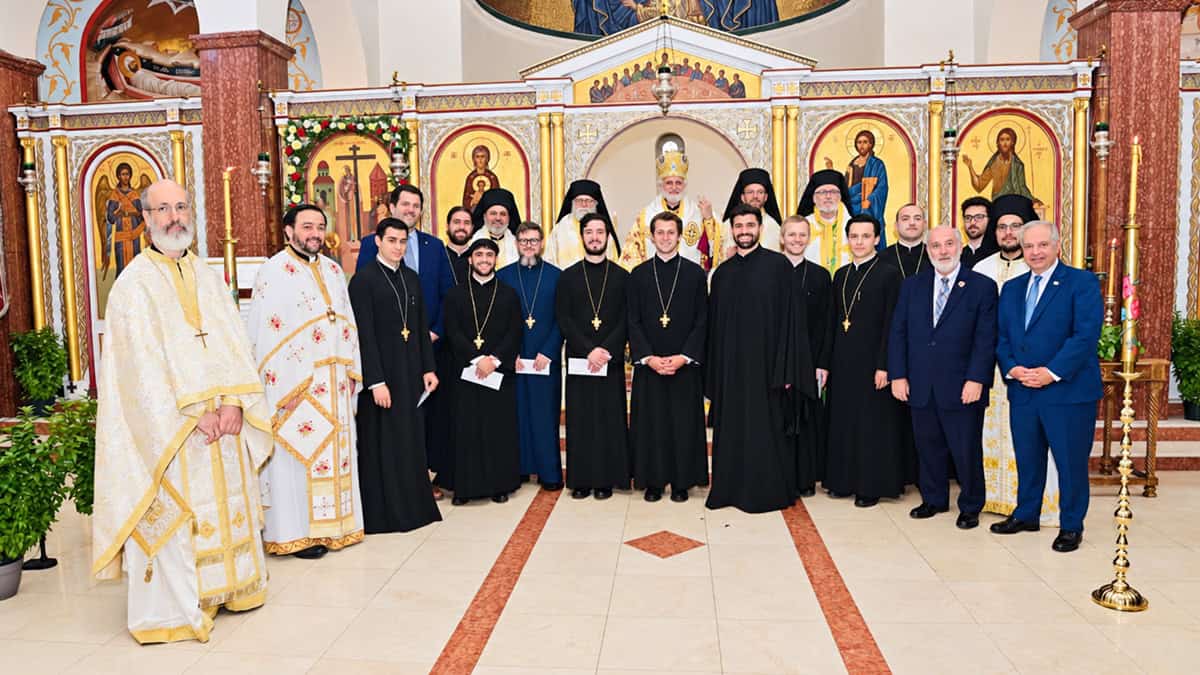 Clergy, seminarians and AHEPA representatives pose for a group photo inside Hellenic College Holy Cross in Brookline.