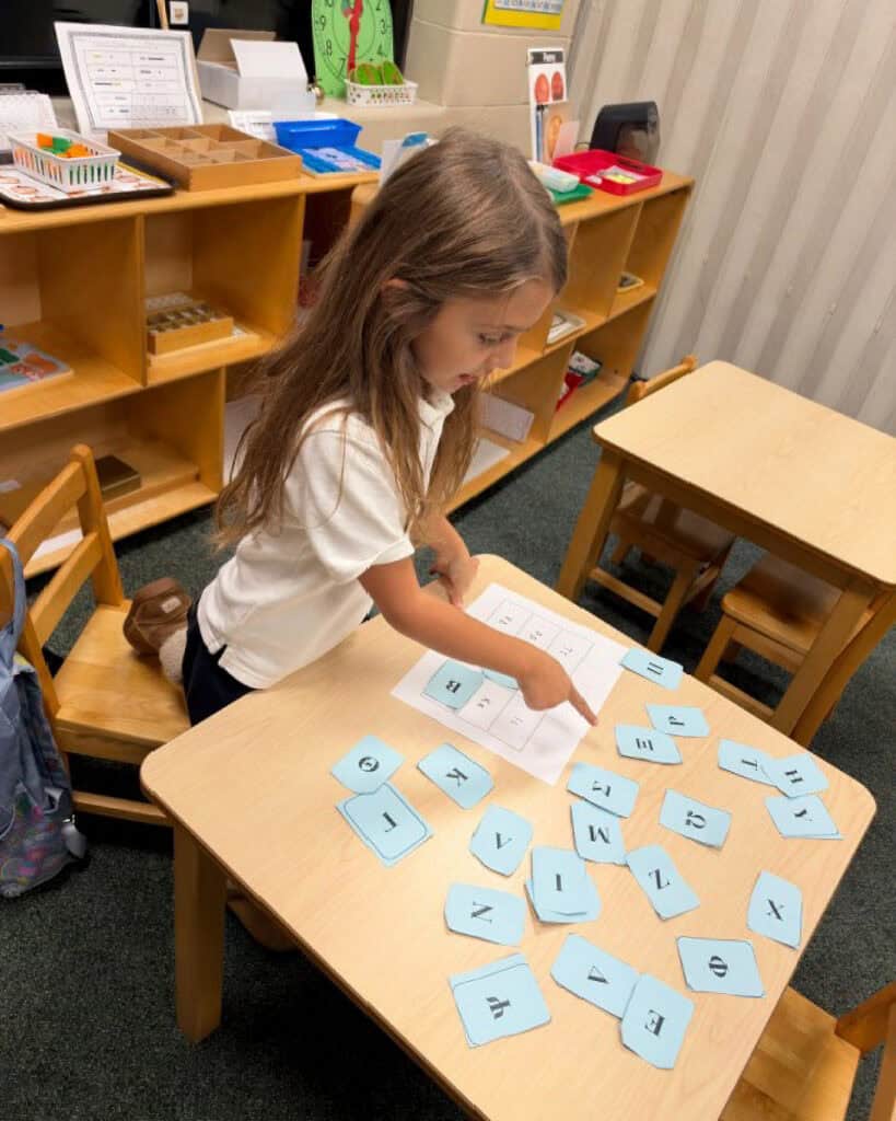 Aristotle Academy student works with Greek-letter cards during a classroom activity in Media, Pennsylvania.