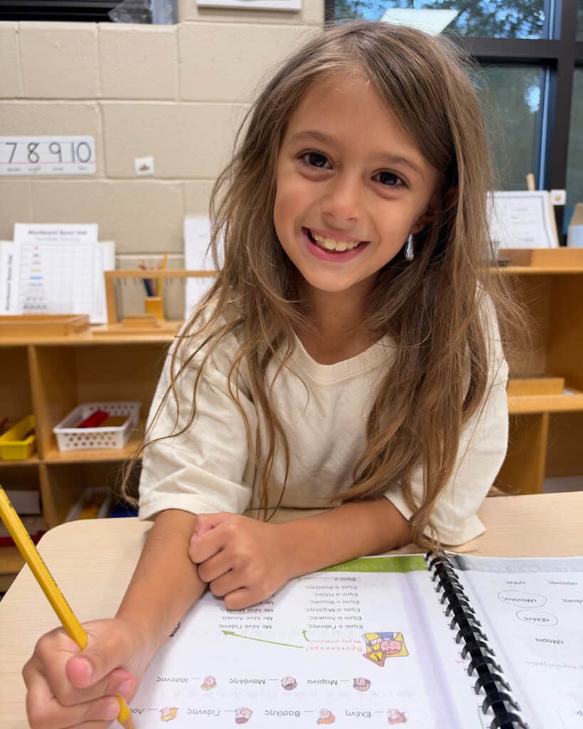 Aristotle Academy student works in a Greek-language workbook during class in Media, Pennsylvania.