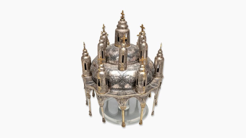 Silver church-shaped artophorion with miniature towers, domes, and crosses.